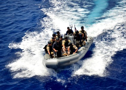 Defense.gov News Photo 120401-N-RI884-011 - Members of a visit board search and seizure team return their rigid-hull inflatable boat to the guided missile destroyer USS Paul Hamilton DDG 60