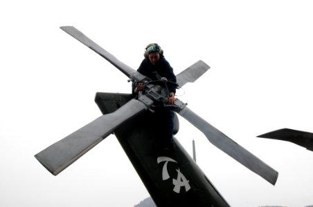 Defense.gov News Photo 120226-N-DX698-193 - U.S. Navy Petty Officer 3rd Class Megan Walters assigned to Helicopter Anti-Submarine Squadron Light 51 conducts a daily inspection on an SH-60F