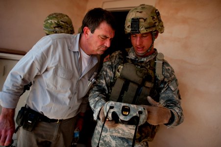 Defense.gov News Photo 120620-D-TT977-177 - U.S. Army Sgt. Donald Armstrong explains a biometric scanning system to Deputy Secretary of Defense Ashton M. Carter during a counter Improvised