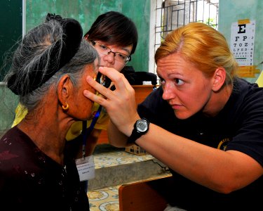 Defense.gov News Photo 120713-N-GW695-025 - U.S. Navy Lt. Ann Tarter right checks a Vietnamese woman s eyes during an exam at a medical civic action project in Vinh Vietnam on July 13