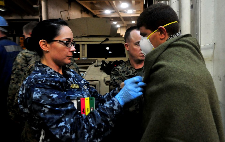 Defense.gov News Photo 120124-N-CT127-251 - A U.S. Navy sailor provides medical care to a rescued Moroccan mariner aboard the amphibious transport dock ship USS Mesa Verde LPD 19 in the