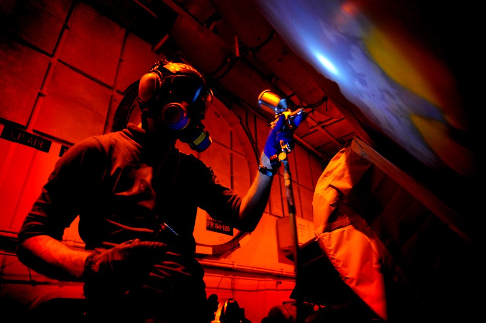 Defense.gov News Photo 120125-N-MD252-759 - Airman David Southworth assigned to Electronic Attack Squadron 134 paints an EA-6B Prowler in the hangar bay aboard the aircraft carrier USS Carl