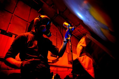 Defense.gov News Photo 120125-N-MD252-759 - Airman David Southworth assigned to Electronic Attack Squadron 134 paints an EA-6B Prowler in the hangar bay aboard the aircraft carrier USS Carl