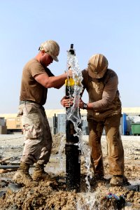 Defense.gov News Photo 120317-N-UH337-029 - Petty Officer Jon M. Wawrek and Petty Officer 2nd Class Michael A. Castaldi both assigned to Naval Mobile Construction Battalion 11 cap an