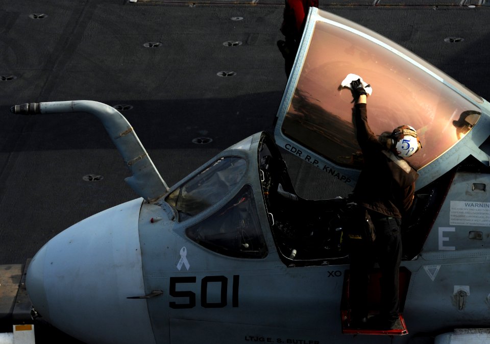 Defense.gov News Photo 120711-N-VO377-104 - A plane captain assigned to Electronic Attack Squadron 131 wipes down the canopy of an EA-6B Prowler on the flight deck of the Nimitz-class aircraft