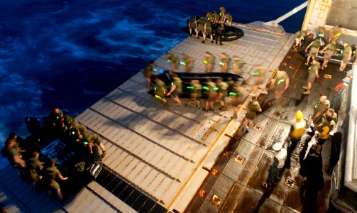 Defense.gov News Photo 120301-N-SS993-295 - Marines from the 31st Marine Expeditionary Unit carry a combat rubber raiding craft to the stern gate of the forward-deployed amphibious dock
