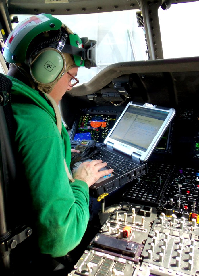 Defense.gov News Photo 120310-N-BL924-002 - Petty Officer 1st Class Charles Cisneros performs diagnostic checks on the mission systems of an MH-60R Sea Hawk helicopter assigned to Helicopter