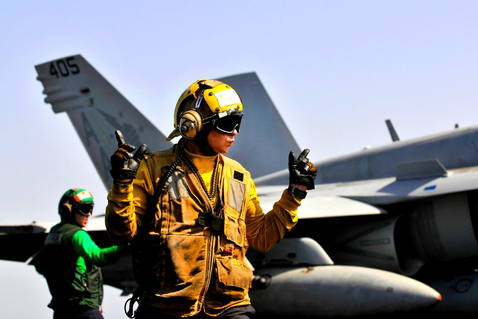 Defense.gov News Photo 120315-N-ZI635-705 - U.S. Navy Seaman Cody Ottmo directs an F A-18C Hornet on the flight deck of the USS Carl Vinson in the Arabian Sea on March 15 2012. Ottmo is an