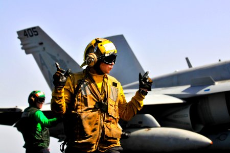 Defense.gov News Photo 120315-N-ZI635-705 - U.S. Navy Seaman Cody Ottmo directs an F A-18C Hornet on the flight deck of the USS Carl Vinson in the Arabian Sea on March 15 2012. Ottmo is an