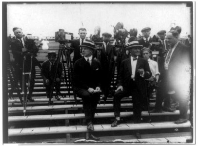Dempsey-Carpentier boxing match at Boyle's Thirty Acres, Jersey City, N.J.- Tex Rickard standing between 2 men in front of photographers LCCN2002718087