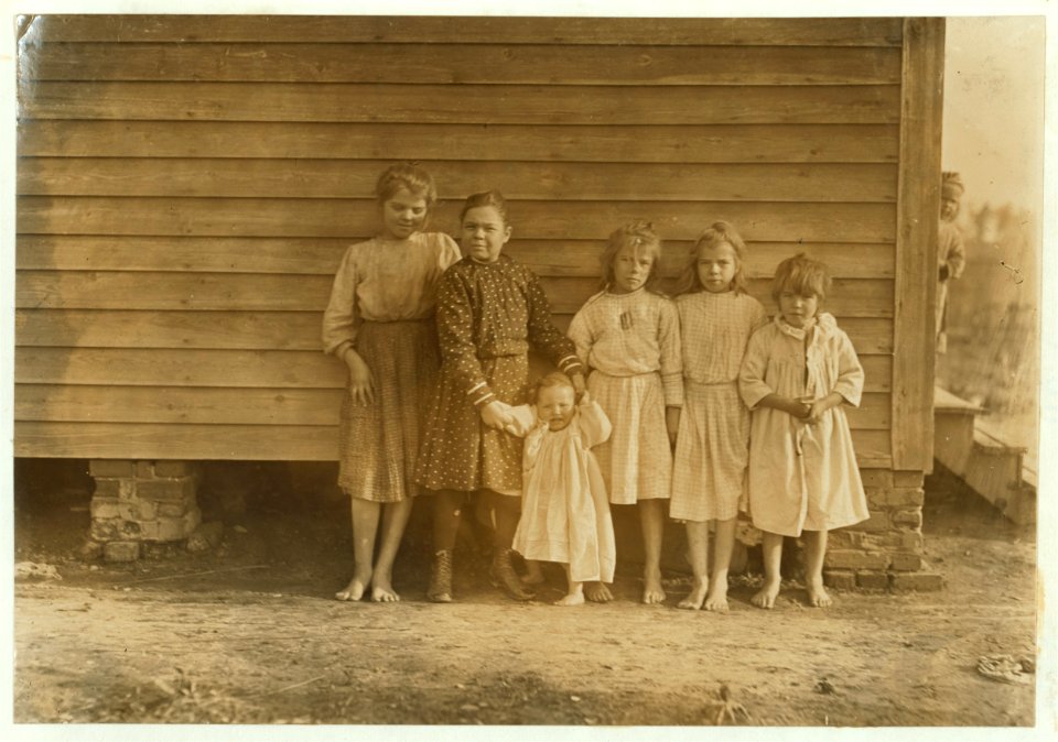 Dillon Mill (tallest) Lizzie McKenzie, Has helped 1-2 year. Mamie Baxley (holding baby). Been in mill 3 years. Runs 4 sides = 40 cents a day. Maud & Daisy 'help.' LOC nclc.01491