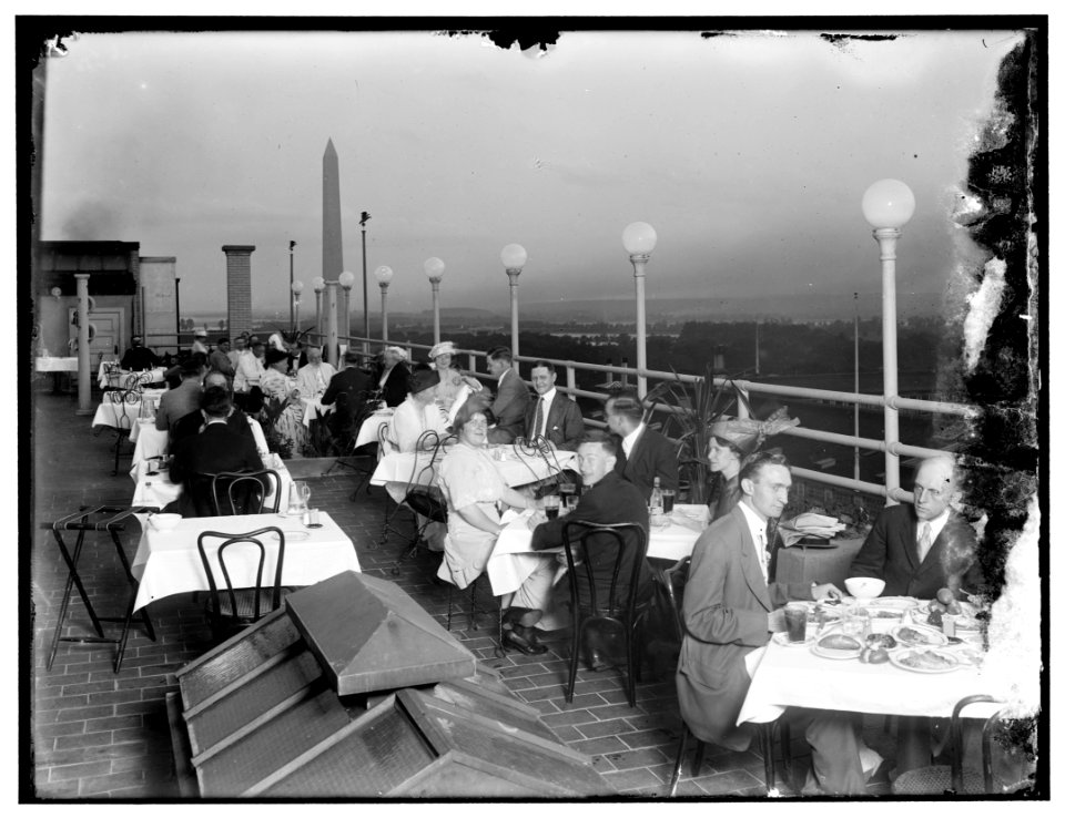Dining on rooftop; Washington monument in background LOC hec.13464