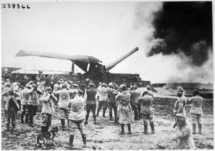 Discharge of a huge French cannon caught by the camera just as the projectile left for the German lines. The gunners... - NARA - 533677 photo