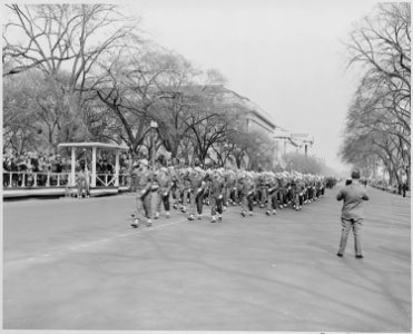 Distance view of President Truman in reviewing stand watching soldiers march by in the Army Day parade. - NARA - 199770