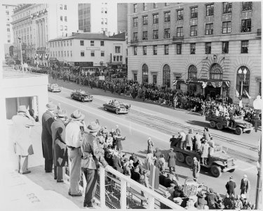 Distance view of President Truman riding in his limousine to the reviewing stand for the inaugural parade. - NARA - 200037 photo