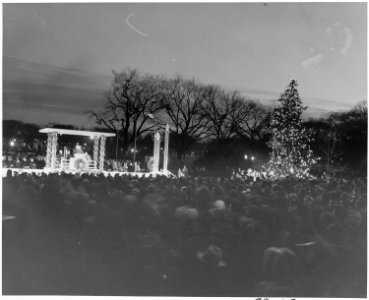 Distance view of President Truman speaking during ceremonies for the lighting of the White House Christmas Tree. - NARA - 199656 photo