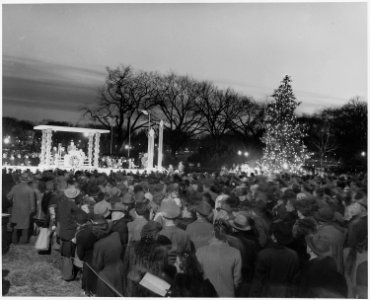 Distance view of the ceremonies for the lighting of the White House Christmas Tree. President Truman is at podium. - NARA - 199669 photo