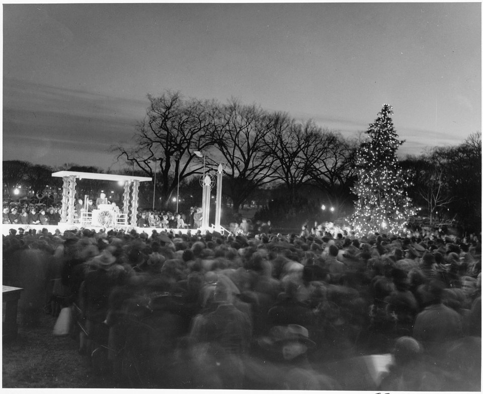 Distance view of President Truman speaking at the ceremonies for the lighting of the White House Christmas Tree. - NARA - 199657 photo