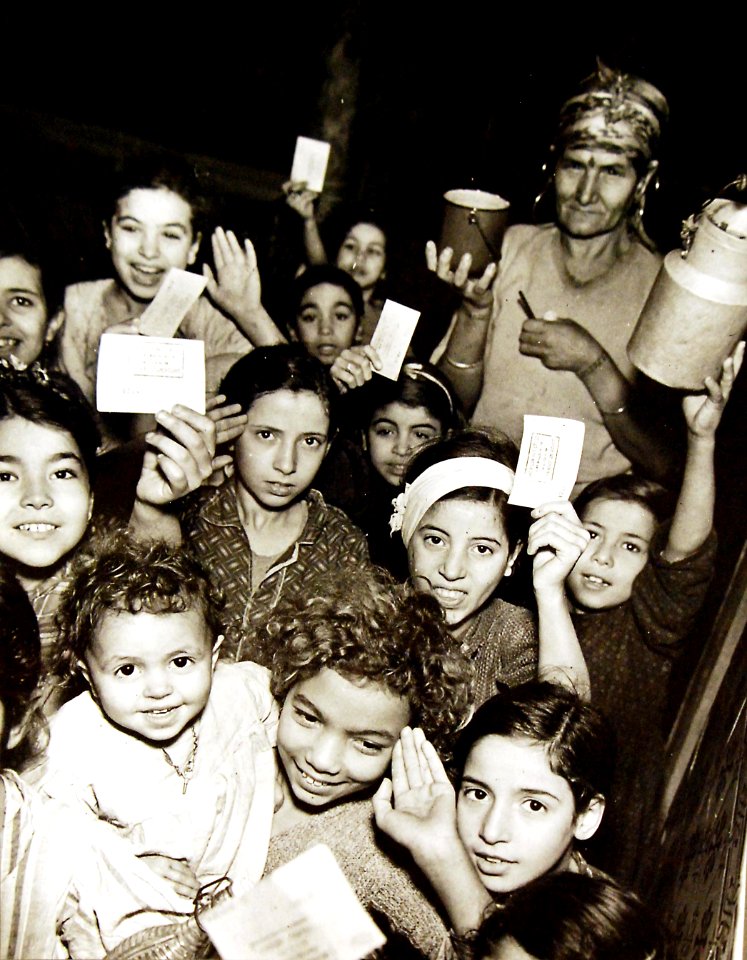 Distribution of milk by Allied civilian relief groups to children in Kasbah, Algeria, 1943 (27503466912)