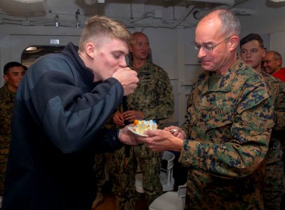 181013-N-GR168-1071 - LT Merlin Stephan feeds SA Jared Carter cake aboard USS New York