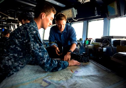 Aaron Eckhart learns to read a map aboard USS Gridley. (8574826764)