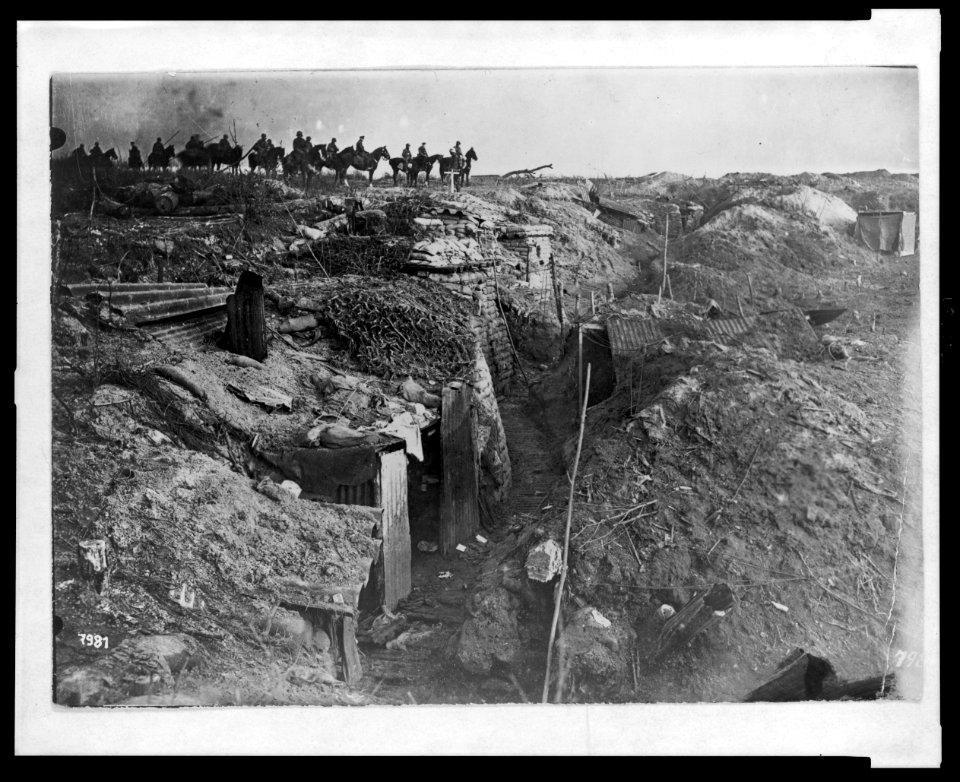 Abandoned British trench which was captured by the Germans; in background, German soldiers on horseback view the scene LCCN2005697195