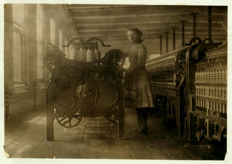 Annie Dugas, spinner at machine on top floor of Glenallen Mill. LOC nclc.02314