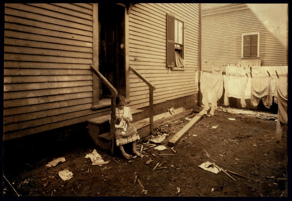 Annie Fedele crocheting on underwear out in the filthy back yard. This is one of the places she works on crochet. See other photos and Home Work report. LOC nclc.04222