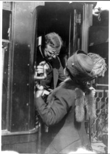 Antwerp, Belgium. T. Roosevelt talking with woman on car step LCCN2010645492