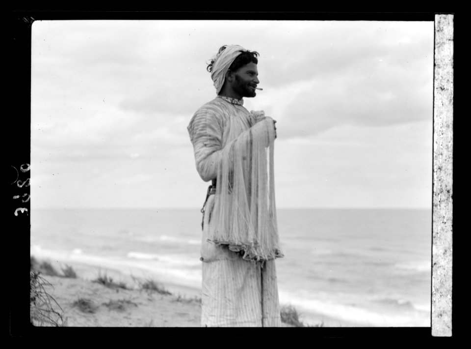 Arab fisherman on the Askalon coast. Holding his throw-net LOC matpc.15655