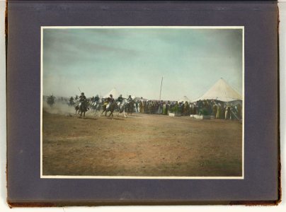 Arab men racing horses while crowd looks on, tents in background LCCN2008676395
