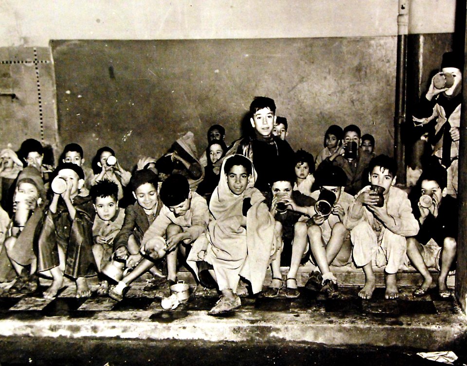 Arabian children receiving milk at school in Algeria, 1943 (27325806010)