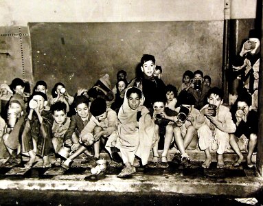 Arabian children receiving milk at school in Algeria, 1943 (27325806010)