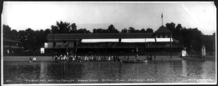 Bathing Pavilions, with people in and out of water- The women's bathing pavilion. Harriet Island, St. Paul, Minn. LCCN2005693312 photo