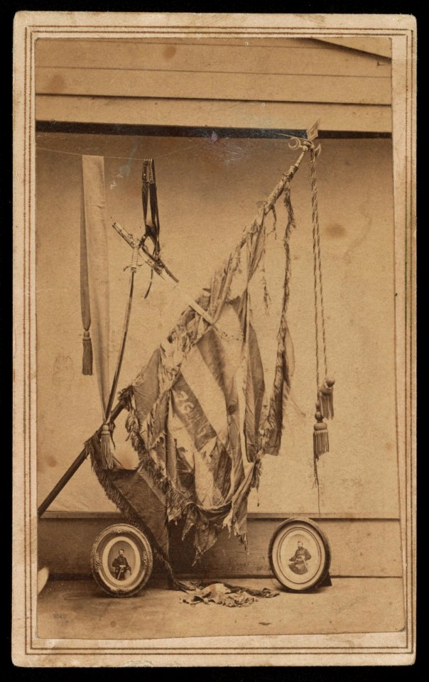 Battle-torn regimental flag of 76th Ohio Infantry Regiment with photographs of Major General Charles Robert Woods and Major Genral William Burnham Woods) - Z.P. McMillen, photographer LCCN2016649602
