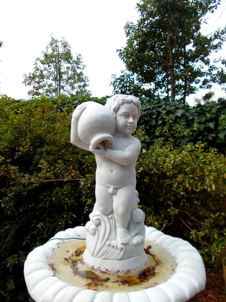Statue of Water pot and nude boy