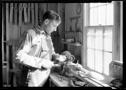 A close-up of one of the men in the shop of the Woodcrafters and Carvers, Gatlinburg, Tennessee. - NARA - 532772 photo