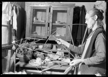 Another view of Mrs. James Watson spinning wool yarn in her cabin near Gatlinburg, Tennessee. - NARA - 532769 photo