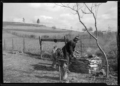 Another view of S. J. Barley, Rural Route ^2, LaFollette, Tennessee, at his outdoor forge. Barley says, `I've just... - NARA - 532722