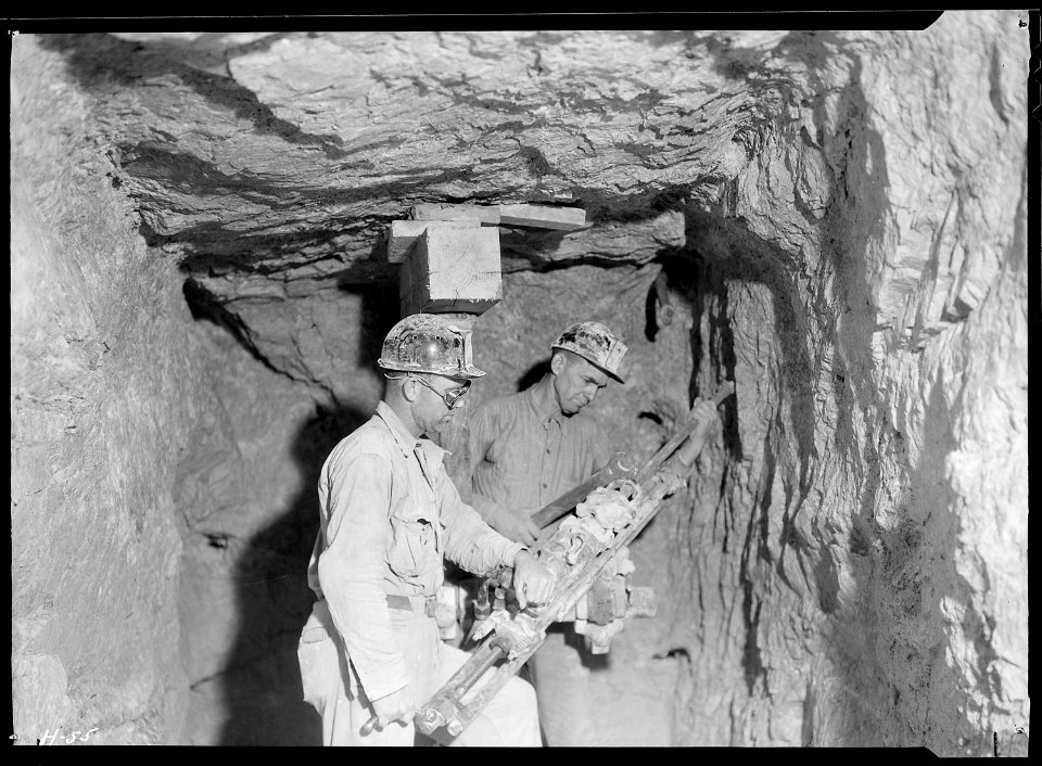 Arthur Roberts and Sam Mynatt drilling in lateral test shaft for examination of substrata at base of Norris Dam. - NARA - 532678