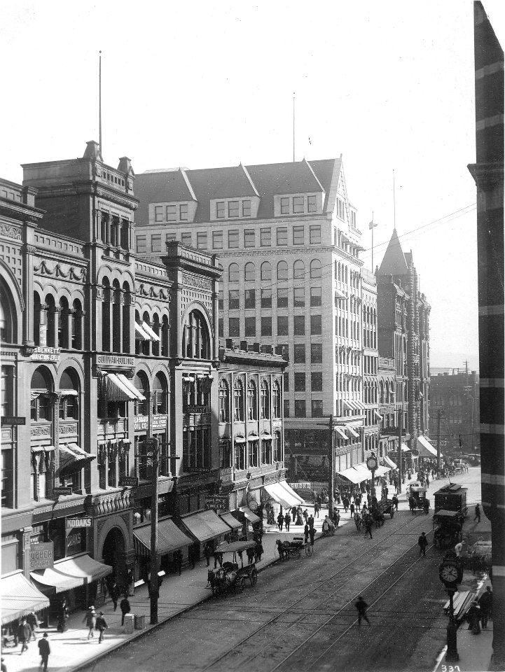 1st Ave, looking south, near the Sullivan Building between Columbia St and Cherry St, Seattle, ca 1900 (WARNER 625)