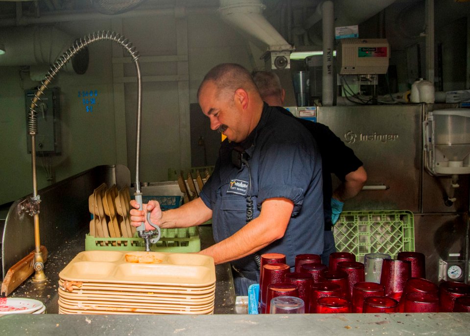 1st Class Petty Officer Association Sailors serve food aboard USS Carl Vinson 141028-N-WD464-164