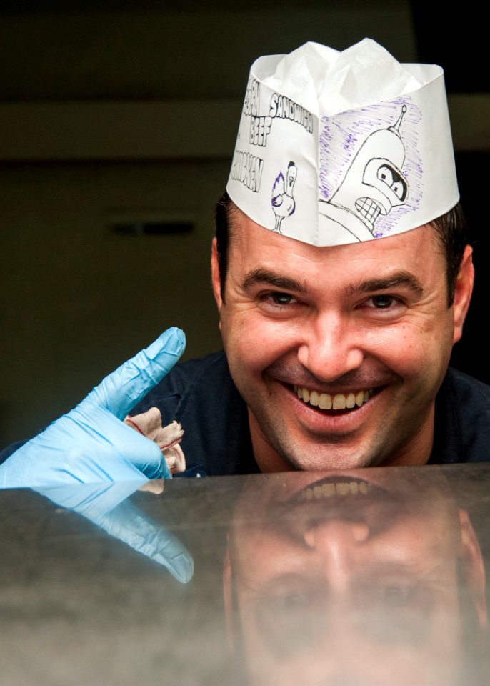 1st Class Petty Officer Association Sailors serve food aboard USS Carl Vinson 141028-N-WD464-151