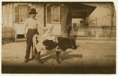 2 'yearlings' belonging to a South Georgia farmer. The former usually gets more attention than the child. John Paulk family. See report of Lewis W. Hine on Georgia, March 1915. LOC nclc.00252