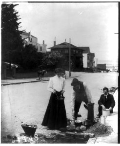 2 men and a woman cooking on the street after the San Francisco earthquake and fire LCCN2002706232