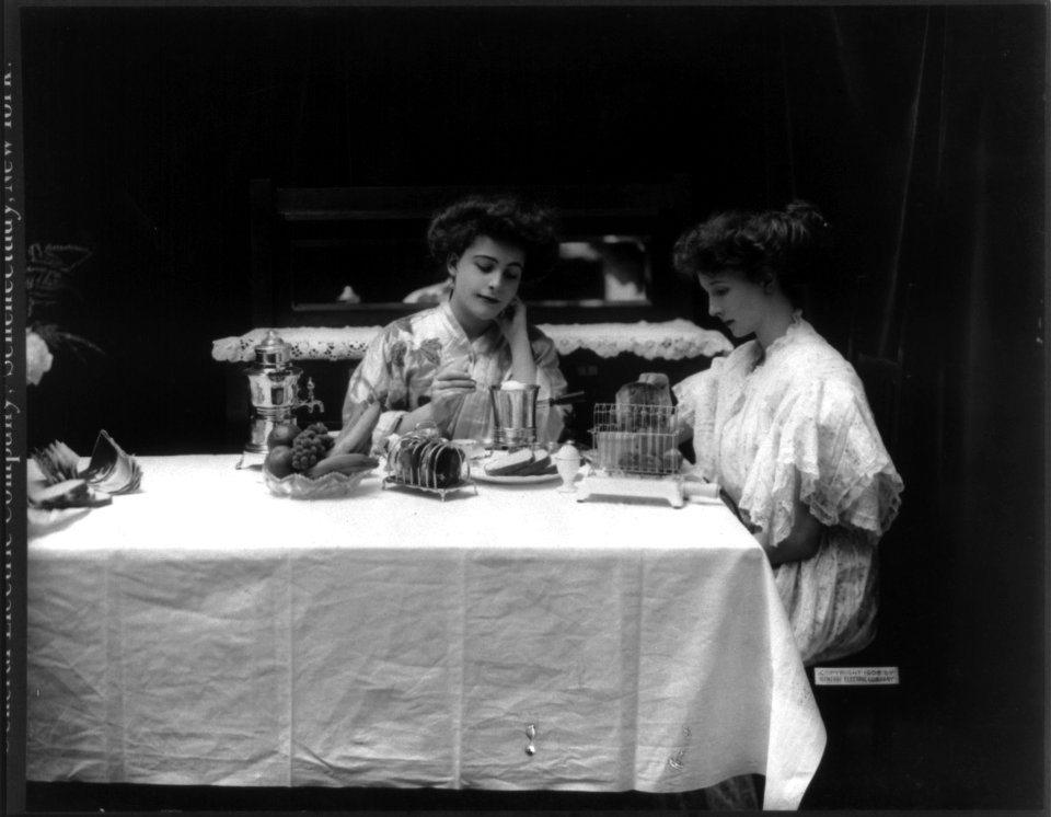 2 women using G.E. appliances- toaster, coffeepot and egg poacher LCCN2006686990