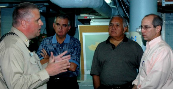 US Navy 060901-N-6544L-002 Master Chief Terrence Gaffney explains communications systems aboard USS Mount Whitney (LCC-JCC 20) to Congressmen