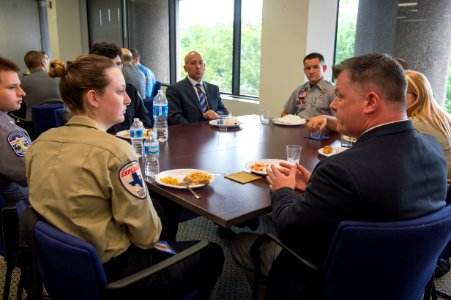 2015 Law Enforcement Explorers Conference eight explorers and mentors around a table photo