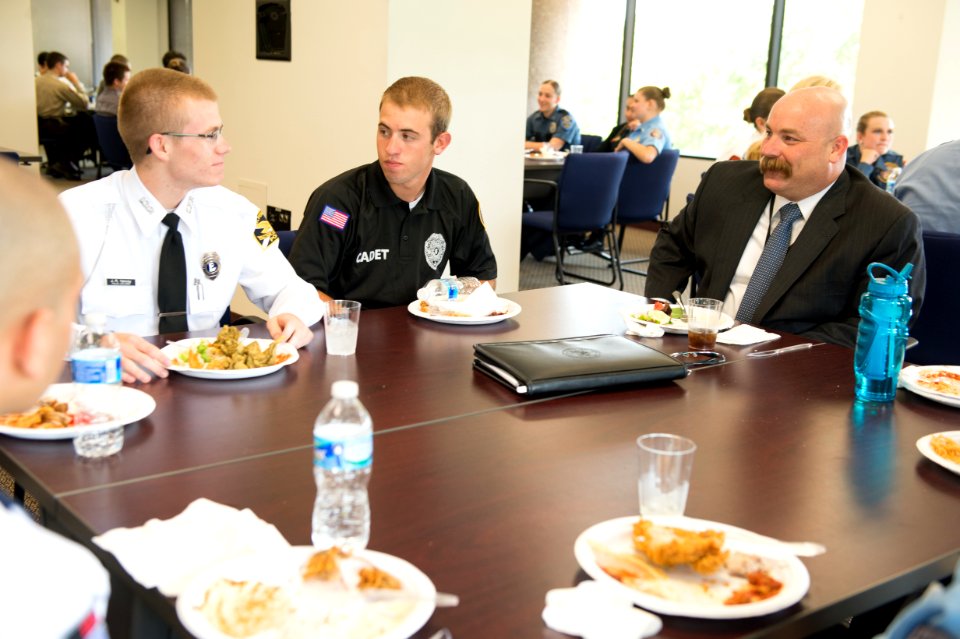 2015 Law Enforcement Explorers Conference man and two explorers during lunch