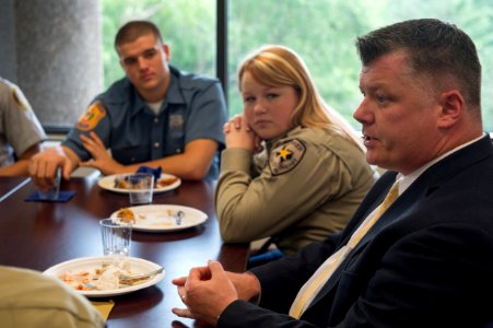 2015 Law Enforcement Explorers Conference man speaks and two explorers listen photo